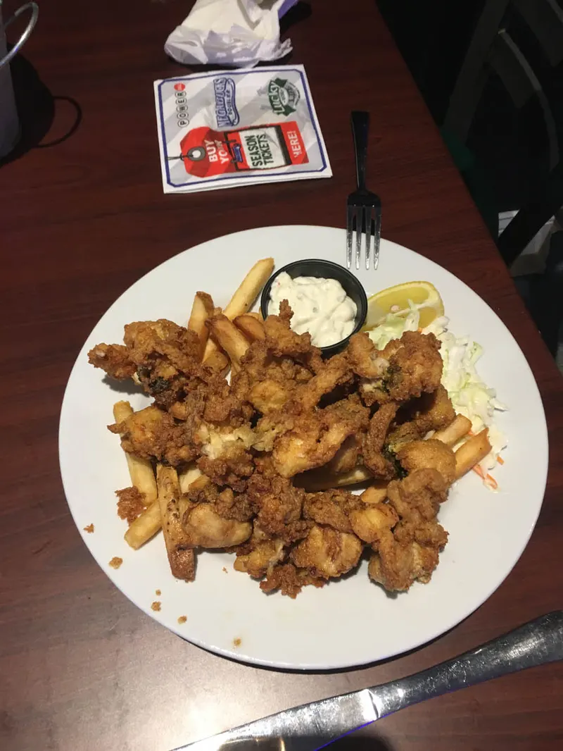 Plate of fried chicken pieces with dipping sauce
