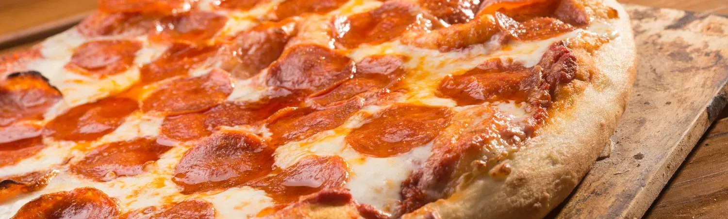 Pepperoni pizza on a wooden board